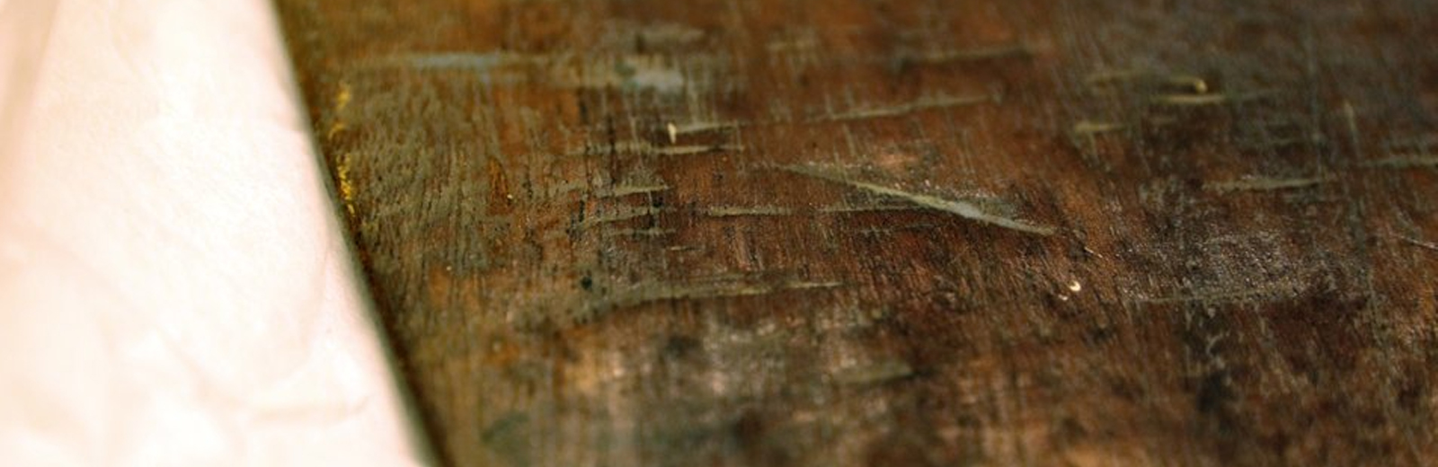Closeup of the edge of Walter Sickert's mahogany artist palette.