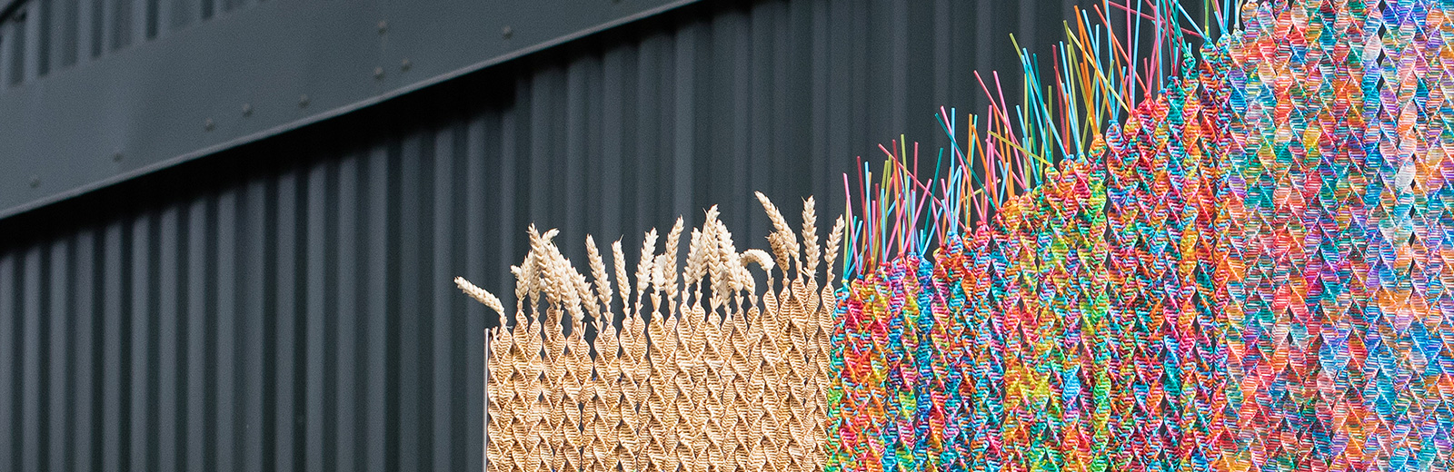 Closeup of one of Maria McKinney's sculptures, made out of wheat and cattle insemination straws.