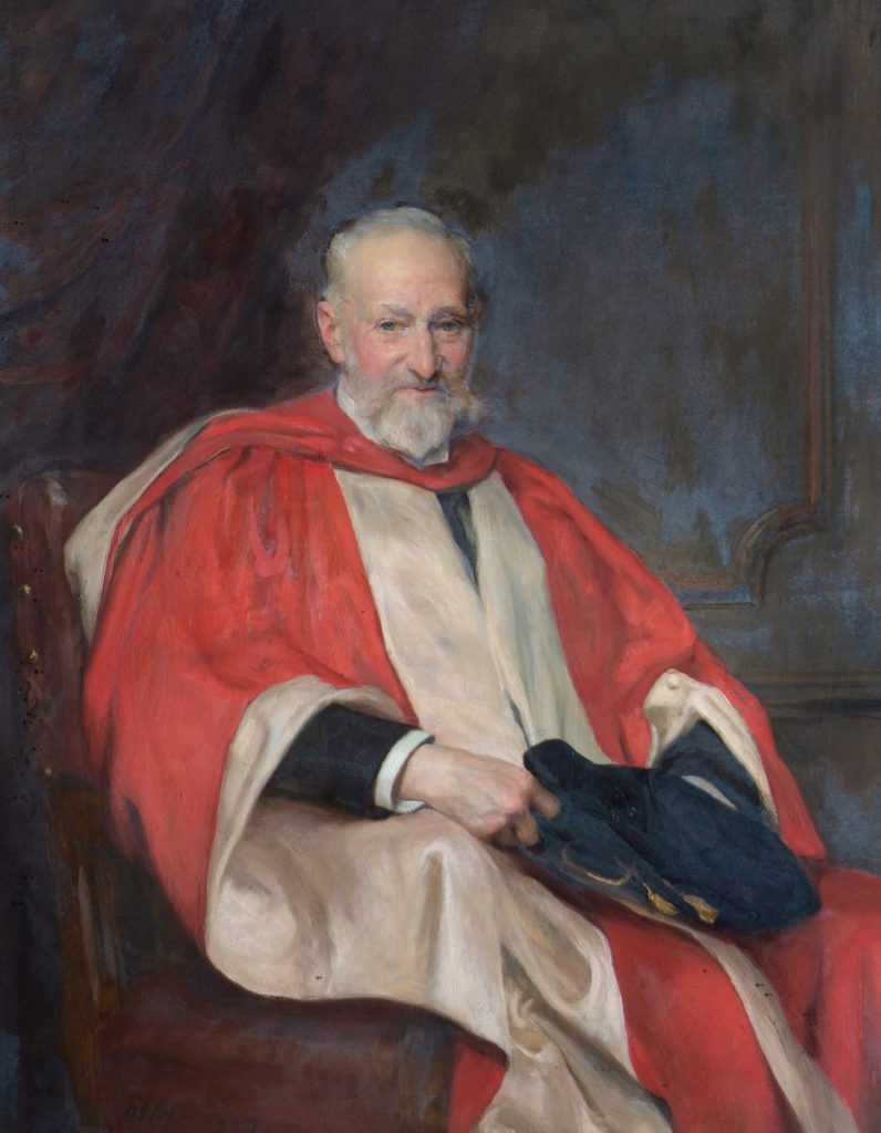 Portrait of Alfred Palmer, seated in red leather chair, wearing red and cream academic robes, and holding his hat, in front of an indistinct panelled wall. Signed.