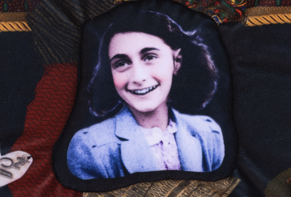 Photo of Anne Frank on a multi-coloured wall hanging