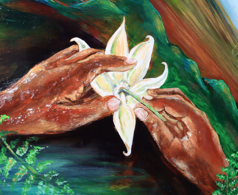 Closeup of a painted globe showing two hands holding a white flower