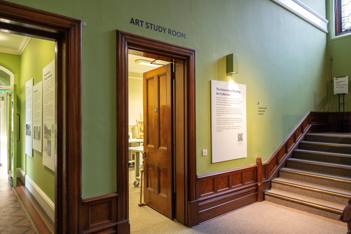 View of an open door between a staircase and a corridor. Above the door is black lettering which reads 'Art Study Room'