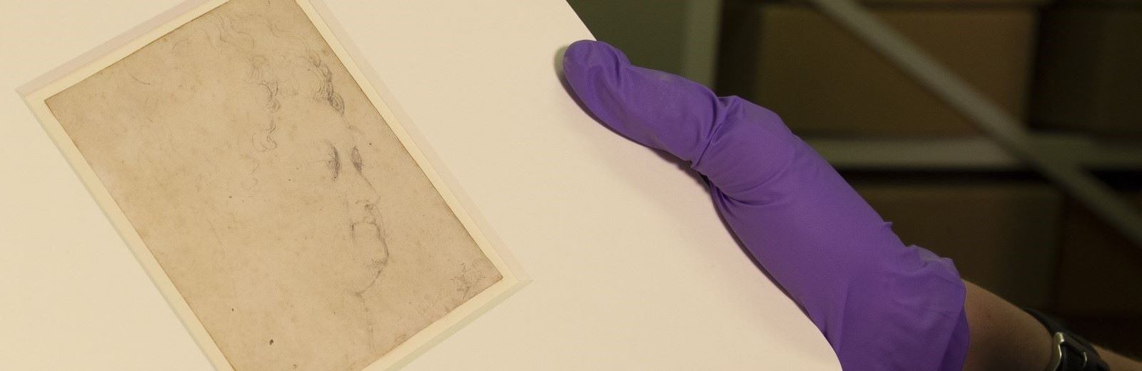 Closeup of Maria de Medici by Peter Paul Rubens. The drawing is being held by a person wearing a purple nitrile glove