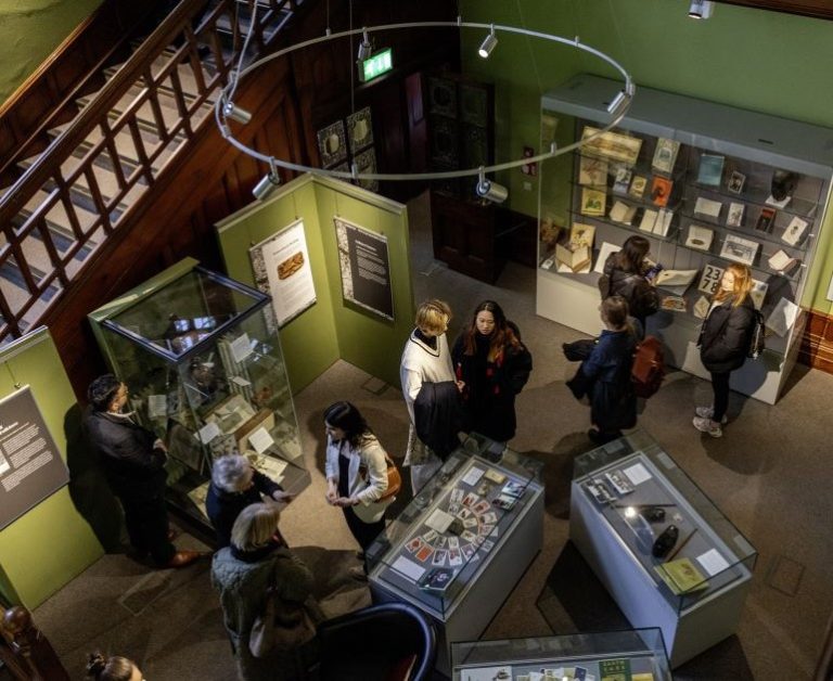 Photograph looking down at people in the staircase hall