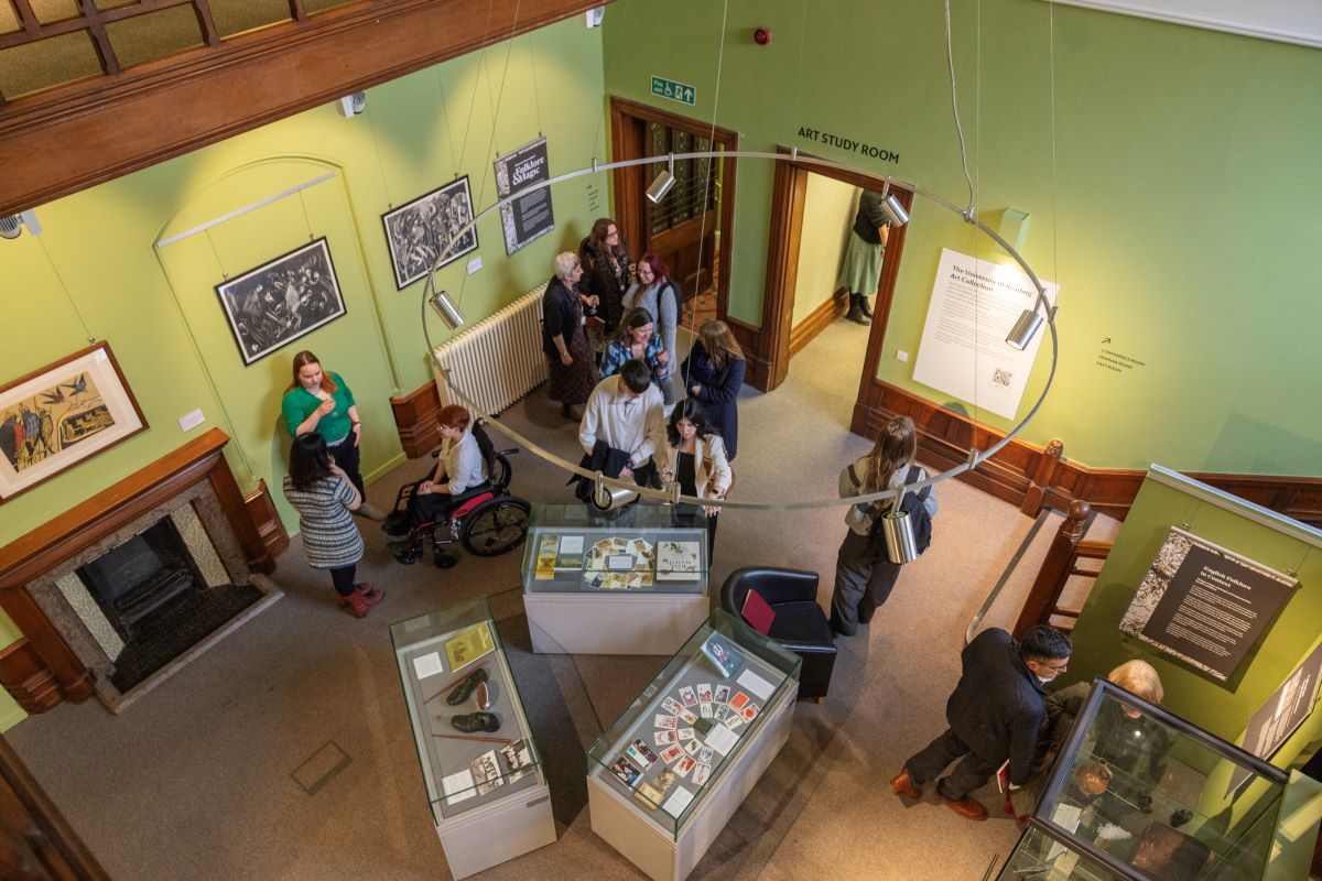 Photograph looking down at people in the staircase hall through the new circular central lighting feature