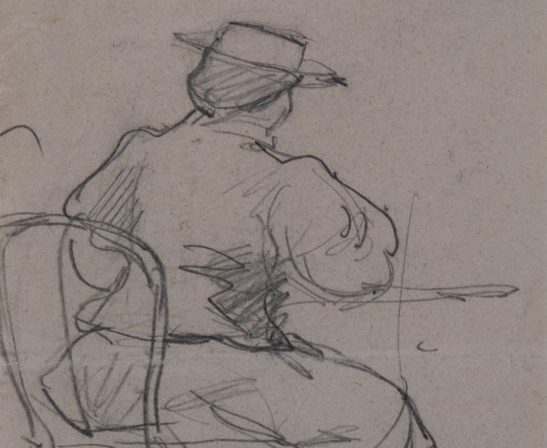 Woman sitting at a table, wearing a hat and visible from behind