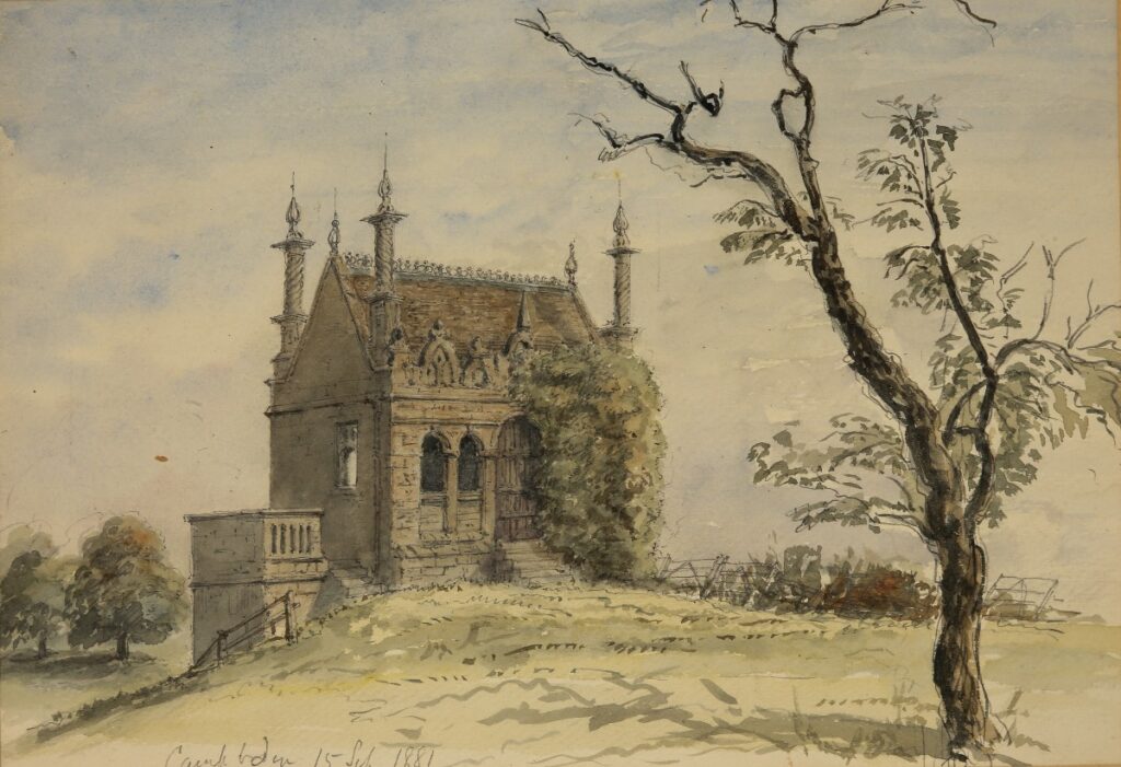 This watercolour with graphite depicts a Jacobean building standing on a gentle rise, its stone façade decorated with pointed arches and intricate detailing. A leafless tree frames the scene, while ivy climbs the structure’s side.