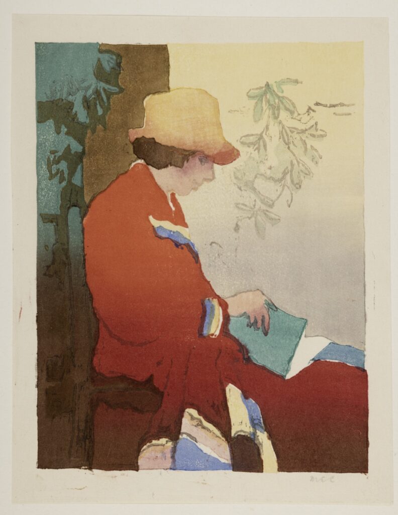 Seated figure wearing a red coat and yellow hat, with a book in their lap.