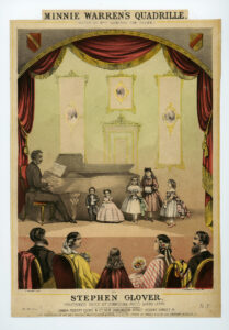Interior view of stage set with performers of short stature and other (child?) performers; pianist at the piano; viewed from behind a row of people in the audience.