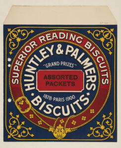 Huntley & Palmers biscuit label showing the company’s red, blue, and gold “garter and buckle” design, reading “Superior Reading Biscuits - Assorted Packets - Grand Prizes, 1878 Paris 1900.
