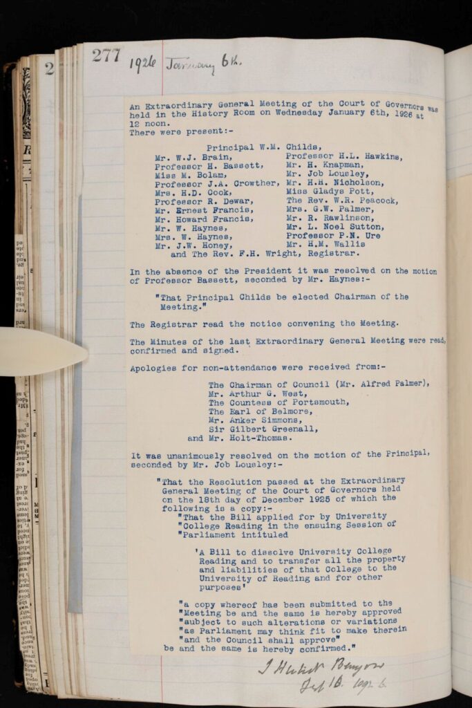 Open minute book showing a typed page dated January 1926, headed “Extraordinary General Meeting of the Court of Governors,” with handwritten annotations in the margins. The page lists attendees, motions, resolutions, and apologies for absence, laid out in formal paragraphs. A handwritten signature appears at the bottom. The bound volume is shown against a dark background, with aged paper edges visible.