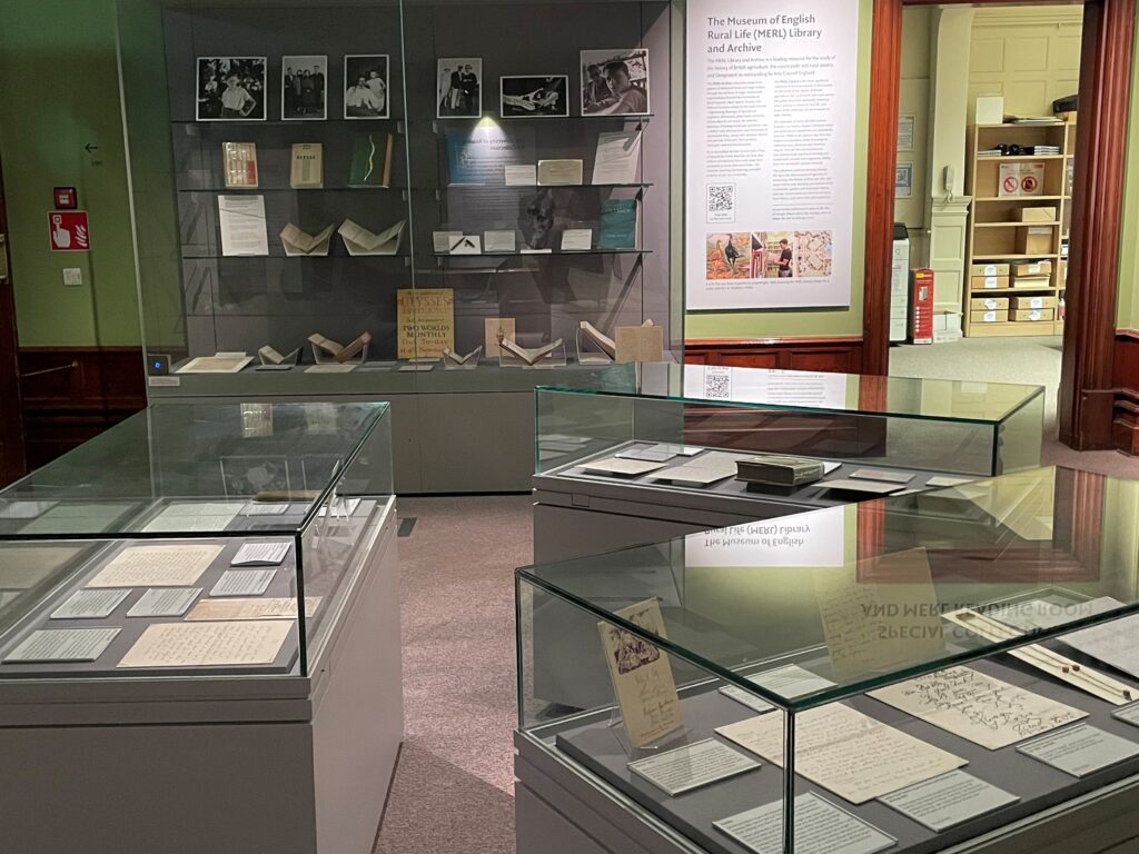Three display cases containing books and letters.
