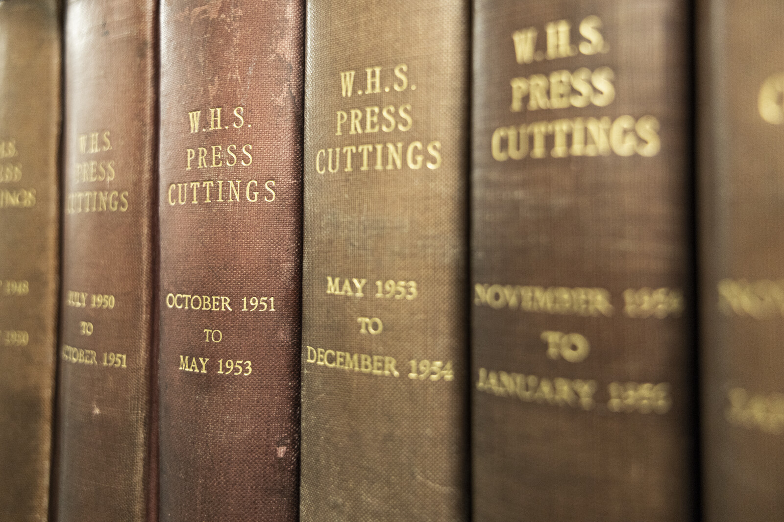 Spines of volumes of W. H. Smith press cuttings, bound with brown cloth and gold lettering